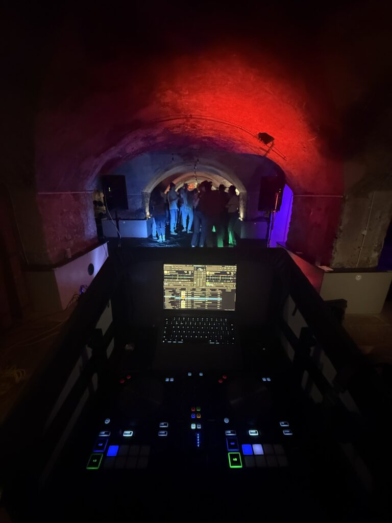 Crypt Disco at The Mount Without DJ booth setup in the crypt at The Mount Without with dancers in the tunnel beyond